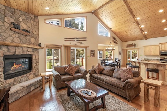 living room featuring hardwood / wood-style flooring, high vaulted ceiling, and a wealth of natural light