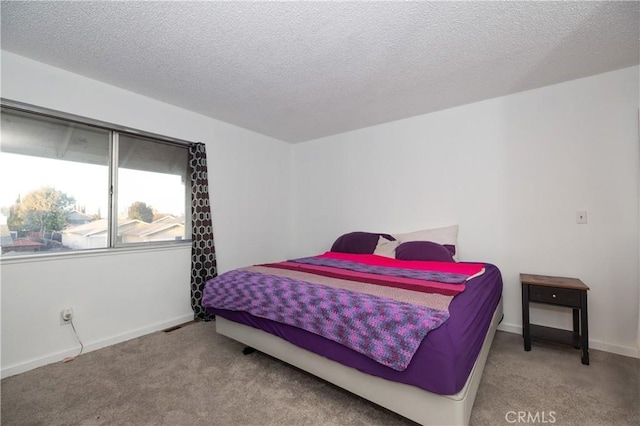 carpeted bedroom with a textured ceiling