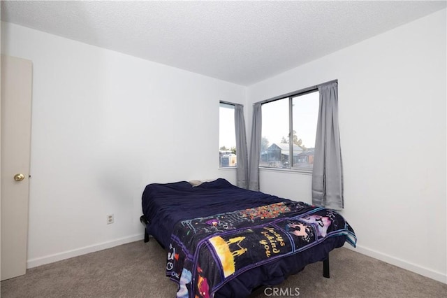 carpeted bedroom featuring a textured ceiling