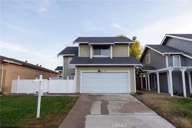 view of front of property with a front lawn and a garage