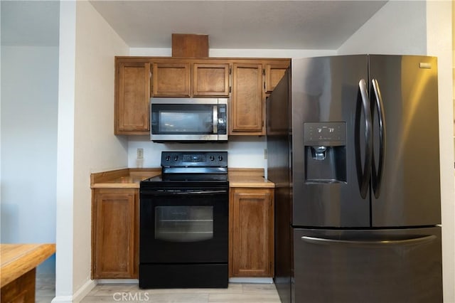 kitchen with stainless steel appliances and light hardwood / wood-style floors