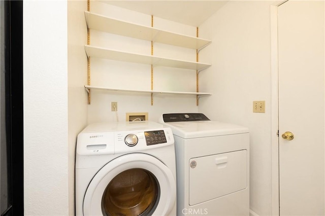 laundry room with washing machine and clothes dryer