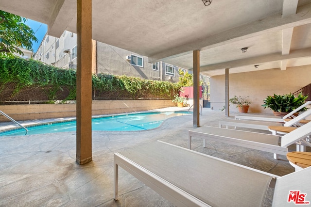 view of swimming pool featuring a patio area