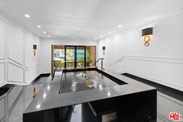 kitchen featuring tile patterned floors, white cabinets, and a spacious island