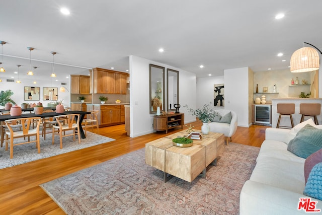 living room featuring wine cooler and light hardwood / wood-style flooring