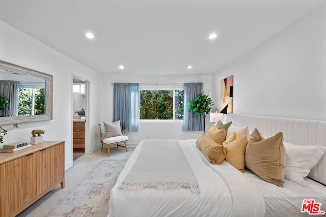 carpeted bedroom featuring connected bathroom