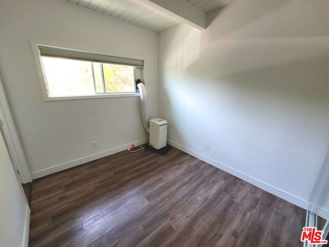 unfurnished room featuring dark hardwood / wood-style floors, lofted ceiling with beams, and wood ceiling