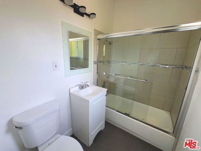 full bathroom featuring vanity, enclosed tub / shower combo, and toilet