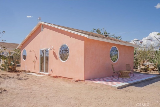 back of property with a patio