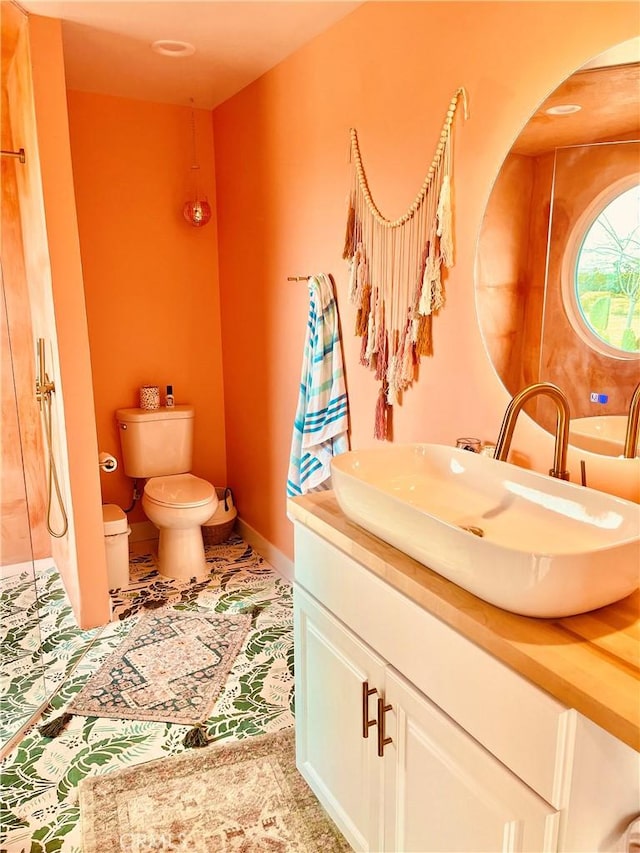 bathroom featuring tile patterned flooring, vanity, and toilet