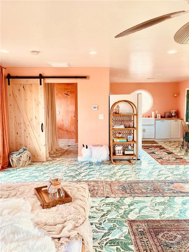 interior space featuring a barn door and carpet floors