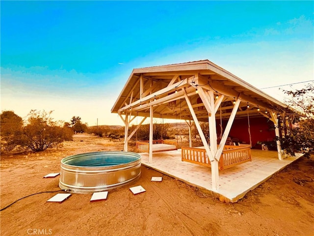 view of property's community featuring a gazebo and a jacuzzi