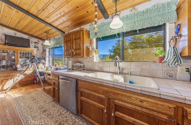 kitchen with tile countertops, a wealth of natural light, and pendant lighting