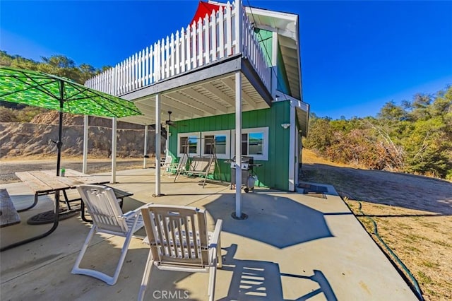 view of patio / terrace with a balcony and a grill