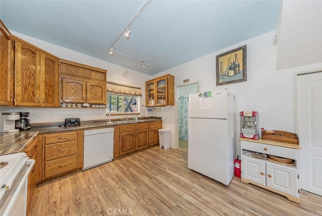 kitchen with sink, track lighting, light hardwood / wood-style floors, and white appliances