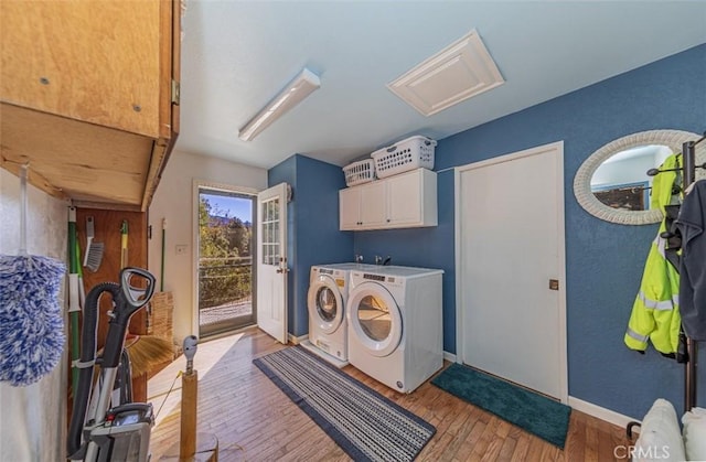 washroom with washer and clothes dryer, cabinets, and light hardwood / wood-style flooring