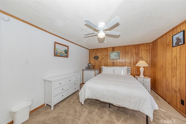 bedroom featuring light carpet, ceiling fan, ornamental molding, and wood walls