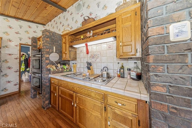 kitchen featuring tile counters, stainless steel appliances, wood-type flooring, decorative backsplash, and wood ceiling