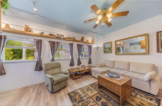 living room featuring ceiling fan, light hardwood / wood-style flooring, and track lighting