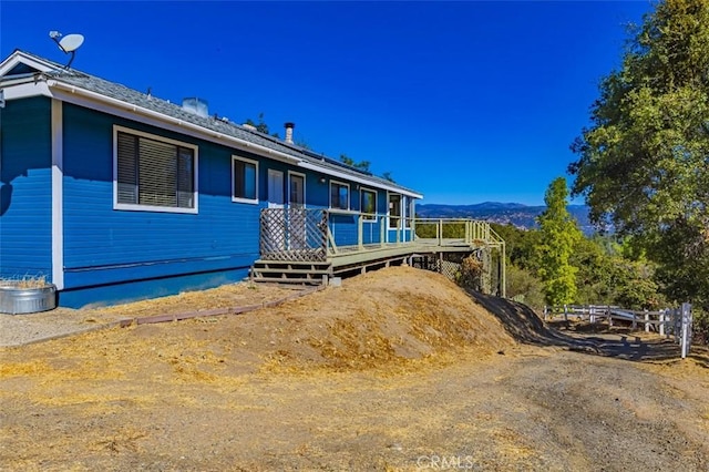 exterior space with a deck with mountain view