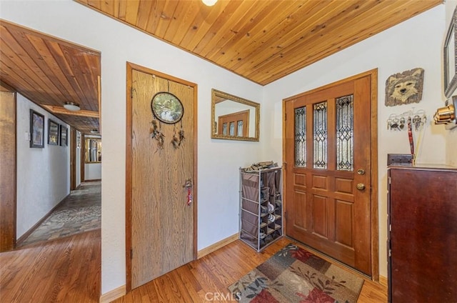 foyer featuring light hardwood / wood-style flooring and wooden ceiling