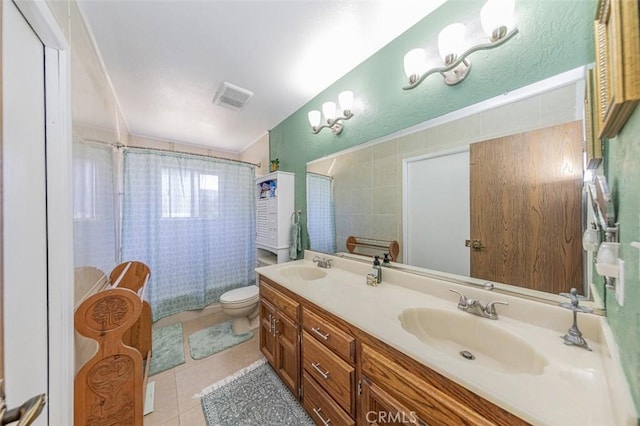 full bathroom with tile patterned floors, vanity, toilet, and shower / bathtub combination with curtain