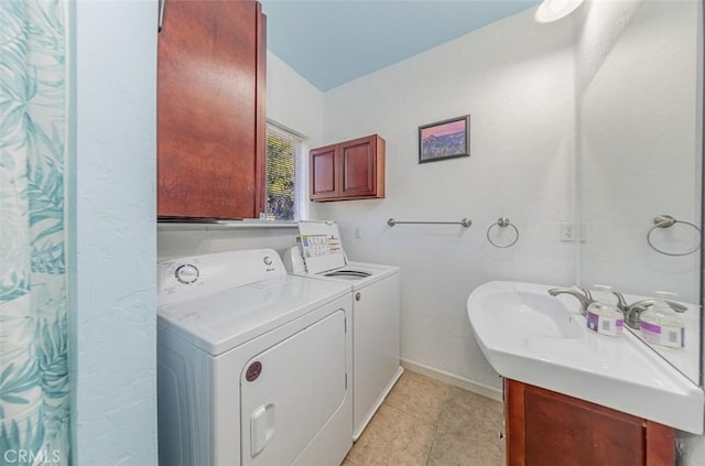 laundry room with washer and dryer, light tile patterned flooring, and sink