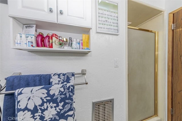 bathroom with a shower with shower door