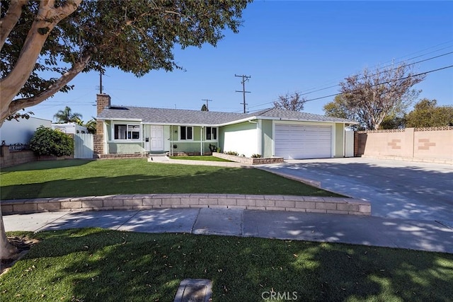 ranch-style house with a garage and a front lawn