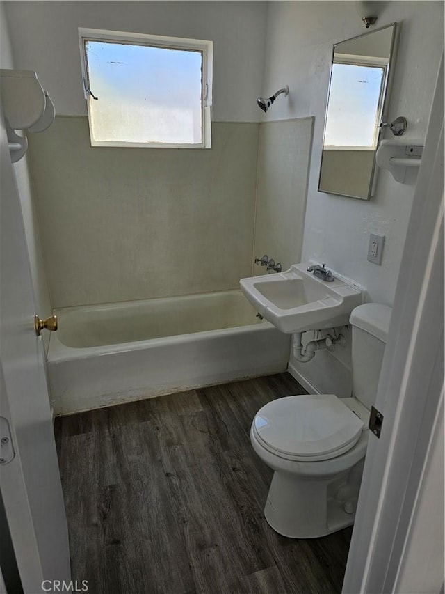 full bathroom featuring plenty of natural light, shower / bath combination, wood-type flooring, and sink