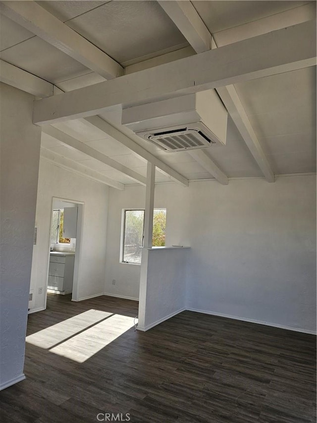 unfurnished room with vaulted ceiling with beams, dark hardwood / wood-style flooring, and a wall unit AC