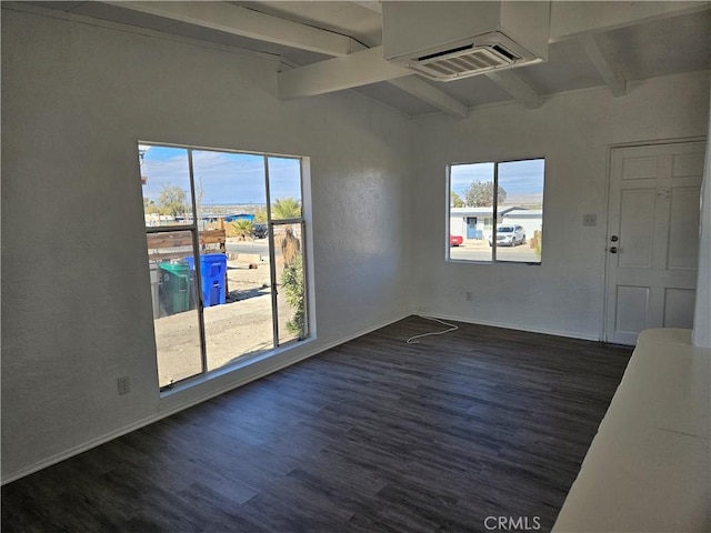 empty room with dark hardwood / wood-style flooring and beamed ceiling