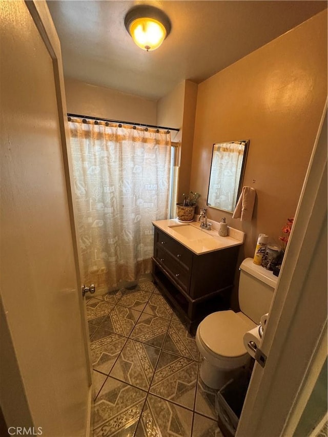 bathroom with tile patterned flooring, vanity, toilet, and a shower with curtain