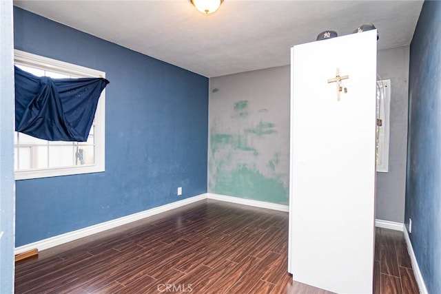 unfurnished room featuring dark hardwood / wood-style floors