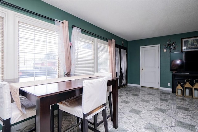 dining room featuring a textured ceiling