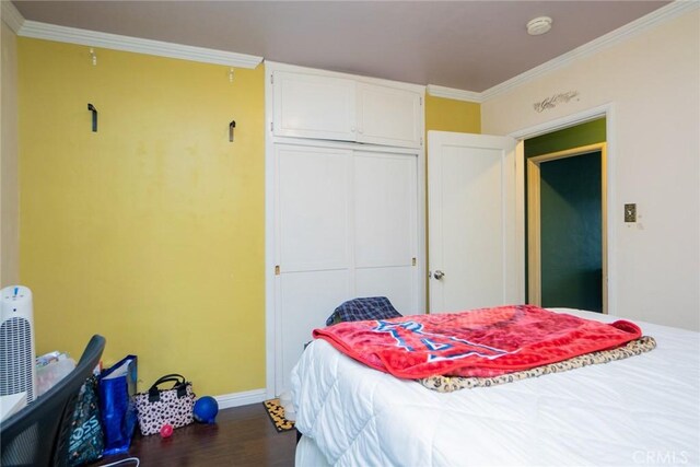 bedroom featuring hardwood / wood-style floors, a closet, and ornamental molding