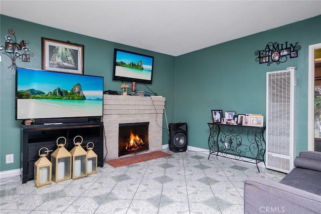 living room featuring a brick fireplace