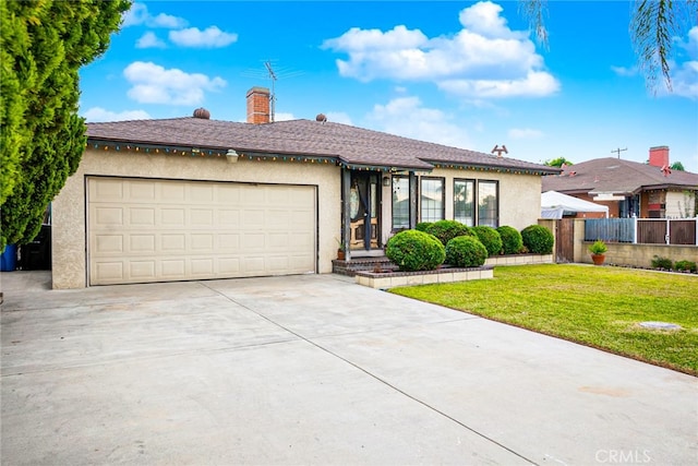 view of front of home with a garage and a front yard