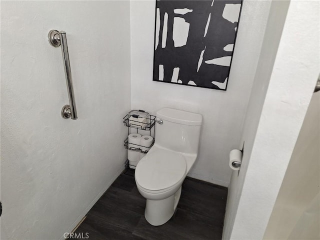 bathroom with hardwood / wood-style floors and toilet