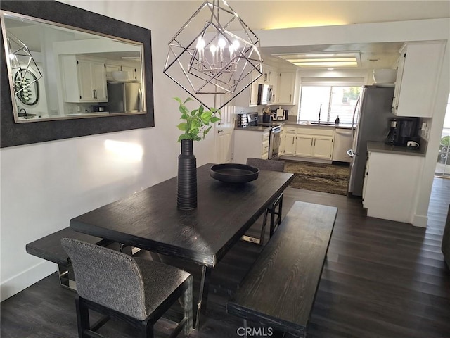 dining space featuring dark hardwood / wood-style floors and a chandelier