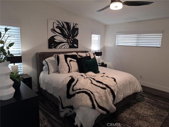 bedroom with ceiling fan and dark wood-type flooring