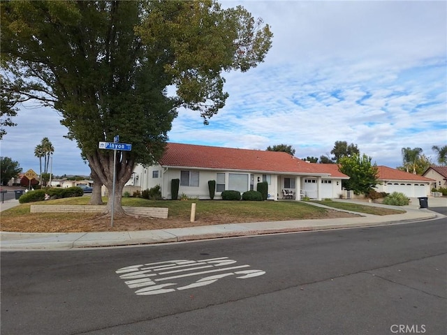 view of front of property with a front yard and a garage