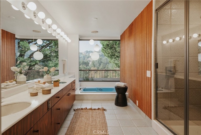 bathroom with tile patterned flooring, vanity, independent shower and bath, and wood walls