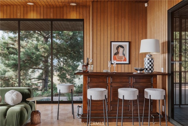 bar featuring wood walls and parquet floors