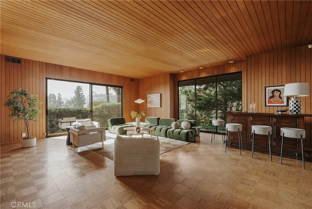 interior space with wood ceiling and wooden walls