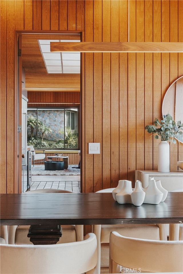 unfurnished dining area with wooden walls