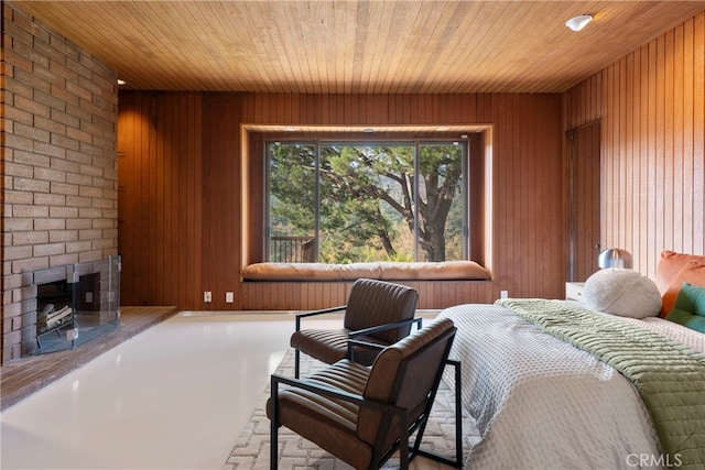 bedroom with a brick fireplace, wooden walls, and wood ceiling