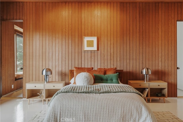 bedroom featuring wooden walls