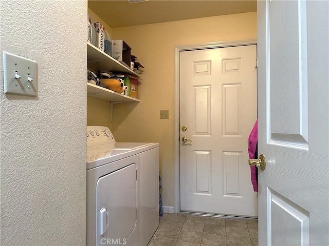 laundry area featuring independent washer and dryer and light tile patterned floors