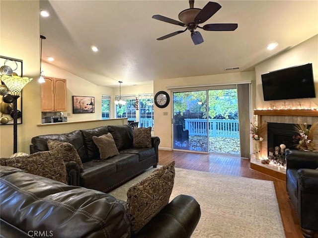 living room featuring ceiling fan, dark hardwood / wood-style flooring, and lofted ceiling